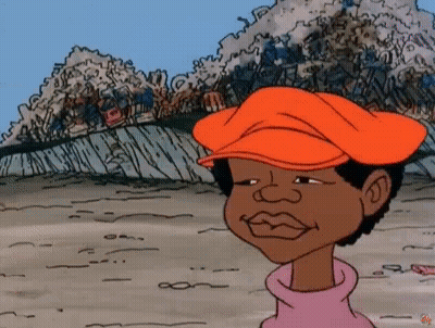 A Cartoon Character Wearing An Orange Hat Is Standing In Front Of A Pile Of Trash . GIF