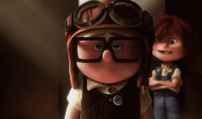 A Cartoon Character Wearing Glasses And A Helmet Is Standing Next To Another Cartoon Character . GIF