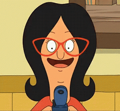 A Cartoon Character Wearing Glasses Is Holding A Cell Phone GIF