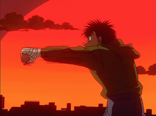A Cartoon Character With A Bandaged Fist Is Standing In Front Of A Sunset GIF