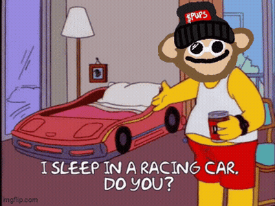 A Cartoon Character With A Beanie That Says Pups Is Standing In Front Of A Racing Car Bed GIF