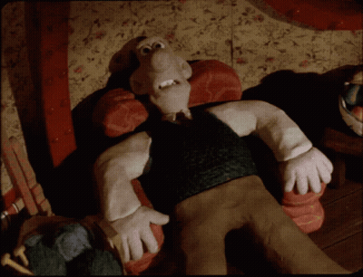 A Cartoon Character With A Big Nose Is Laying On A Couch GIF