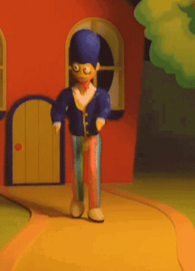 A Cartoon Character With A Blue Hat Is Walking Down A Path GIF