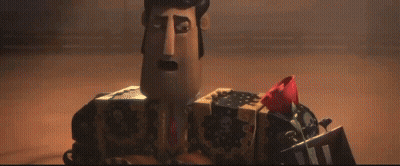 A Cartoon Character With A Box On His Head Holding A Red Rose . GIF