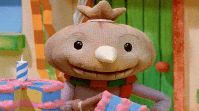 A Cartoon Character With A Crown On His Head Is Holding A Cake GIF