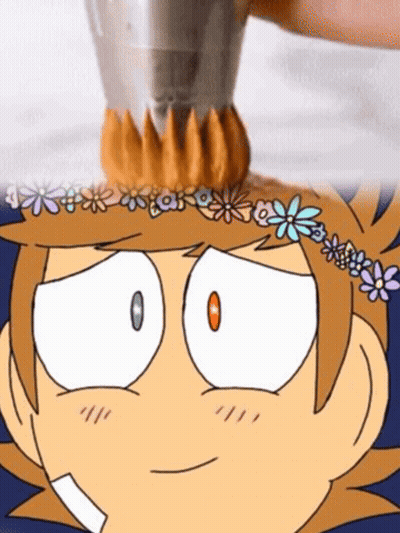 A Cartoon Character With A Flower Crown On His Head Is Being Decorated With Frosting . GIF