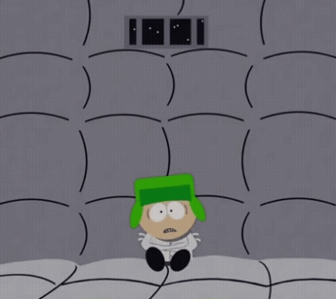 A Cartoon Character With A Green Hat Is In A Cell GIF
