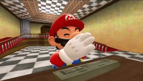 A Cartoon Character With A M On His Hat Is Sitting At A Table With A Remote Control . GIF