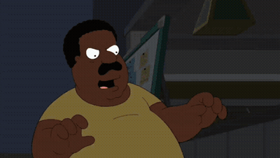A Cartoon Character With A Mustache And A Yellow Shirt Stands In Front Of A Computer Monitor GIF