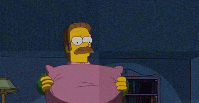 A Cartoon Character With A Mustache Is Holding A Pink Pillow . GIF