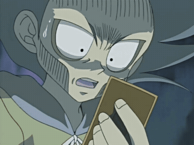 A Cartoon Character With A Surprised Look On His Face Holds A Card GIF
