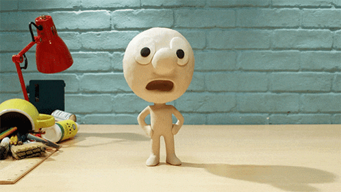 A Cartoon Character With A Surprised Look On His Face Stands On A Desk GIF