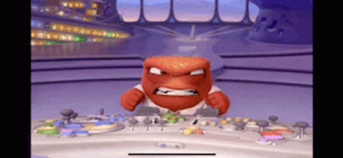 A Cartoon Character With An Angry Face Is Sitting At A Desk GIF