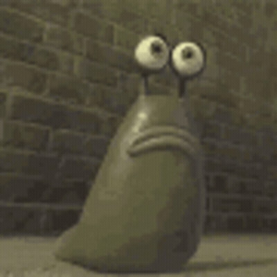 A Cartoon Character With Big Eyes Is Sitting In Front Of A Brick Wall With Its Mouth Open . GIF