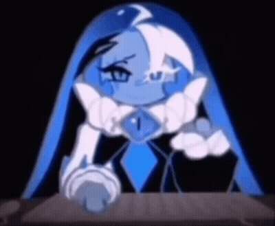 A Cartoon Character With Blue Hair And A Blue Necklace Is Sitting At A Table In A Dark Room . GIF