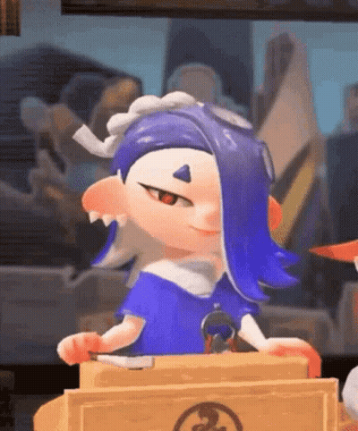 A Cartoon Character With Blue Hair Is Sitting At A Table Holding A Knife And Smiling . GIF