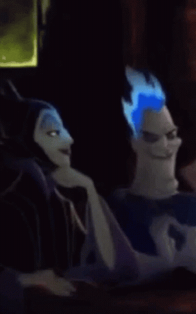 A Cartoon Character With Blue Hair Is Sitting Next To Another Cartoon Character And Making A Funny Face . GIF
