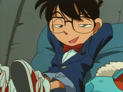 A Cartoon Character With Glasses And A Bow Tie Is Sitting On A Chair GIF