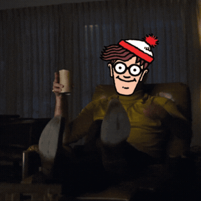 A Cartoon Character With Glasses And A Red White And Blue Hat Is Pointing At Something GIF