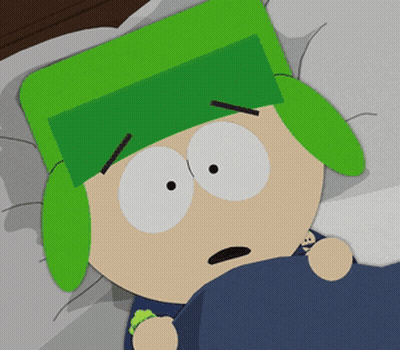 A Cartoon Character With Green Ears And A Green Hat Laying In Bed GIF