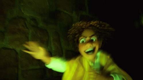 A Cartoon Character With Green Eyes Is Standing In Front Of A Stone Wall . GIF