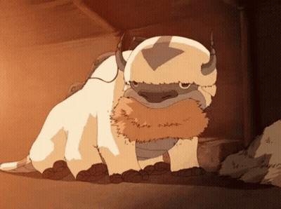 A Cartoon Character With Horns And A Beard Is Standing In A Cave . GIF