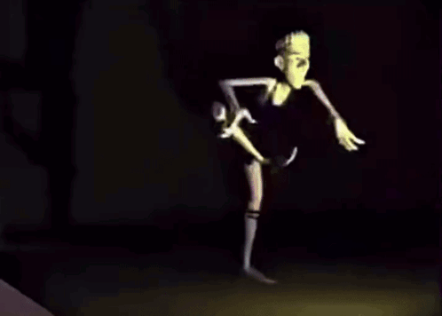 A Cartoon Character With Long Arms And Legs Is Dancing In The Dark . GIF