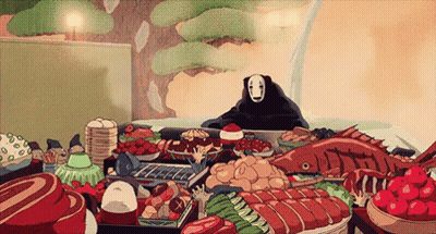 a cartoon character with no face is sitting at a table filled with lots of food .
