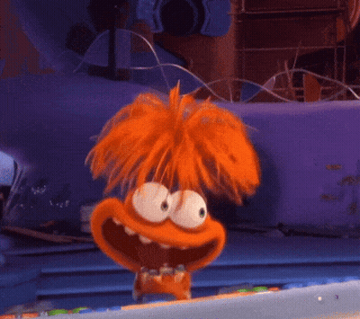 A Cartoon Character With Orange Hair Is Standing In Front Of A Purple Wall GIF