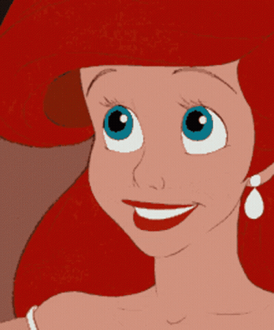 A Cartoon Character With Red Hair And Blue Eyes Is Smiling GIF