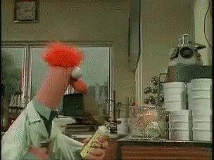 A Cartoon Character With Red Hair Is Holding A Bottle Of Hot Sauce GIF