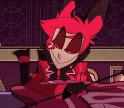 A Cartoon Character With Red Hair Is Sitting On A Bed And Smiling . GIF
