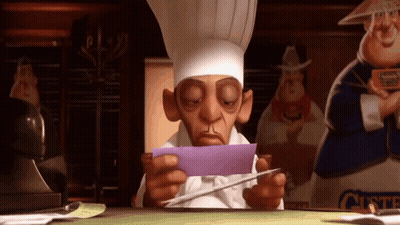 A Cartoon Chef Is Sitting At A Desk Holding A Piece Of Purple Paper . GIF