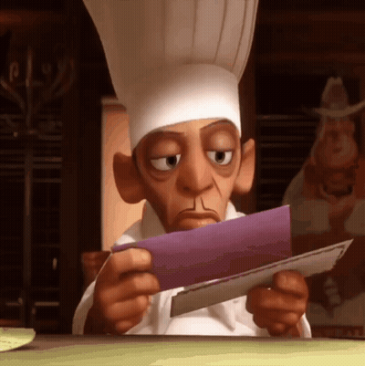 A Cartoon Chef Looks At A Piece Of Paper GIF