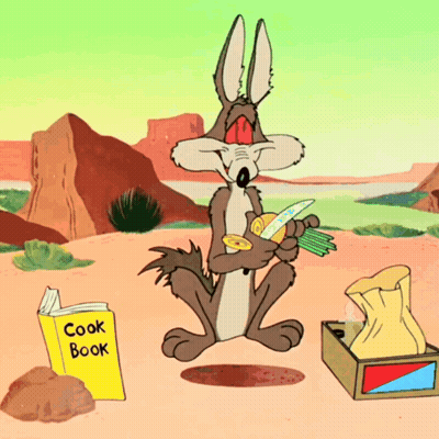 A Cartoon Coyote Sits Next To A Cook Book In The Desert GIF