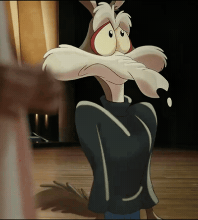 A Cartoon Coyote With A Black Jacket On Is Standing On A Stage GIF