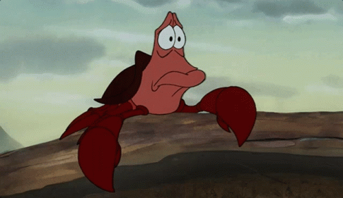 A Cartoon Crab Is Sitting On A Log With A Sad Look On Its Face GIF