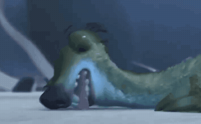 A Cartoon Dinosaur Is Laying On The Ground With Its Mouth Open And A Person In The Background . GIF