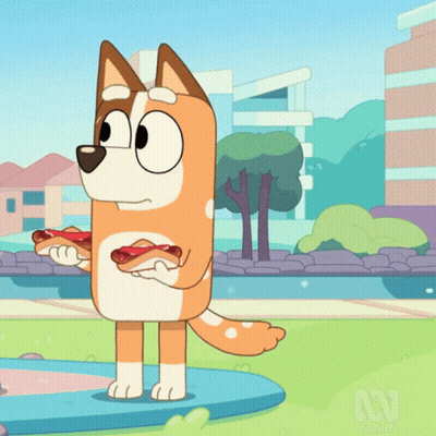 A Cartoon Dog Is Holding A Hot Dog In His Paws GIF