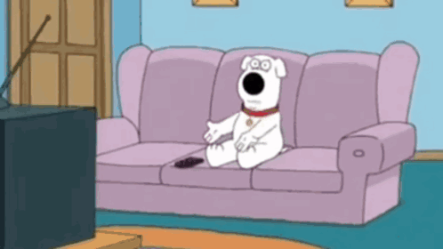 Cartoon Dog Sitting On Couch With Remote GIF