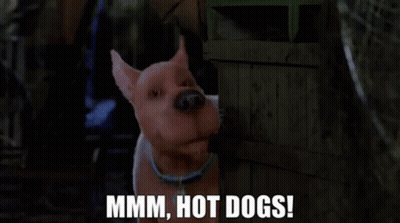 A Cartoon Dog Is Standing Next To A Wooden Crate And Says Mmmm Hot Dogs ! GIF
