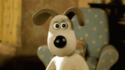 A Cartoon Dog With Big Eyes Is Sitting In A Chair GIF