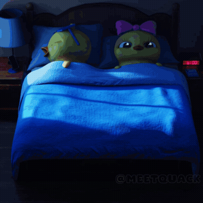 A Cartoon Drawing Of A Duck Laying On A Bed GIF