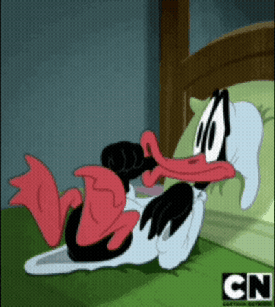 A Cartoon Duck Is Laying On A Bed With Cn Written On The Bottom GIF