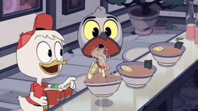 A Cartoon Duck Is Reading A Book While Eating Noodles GIF