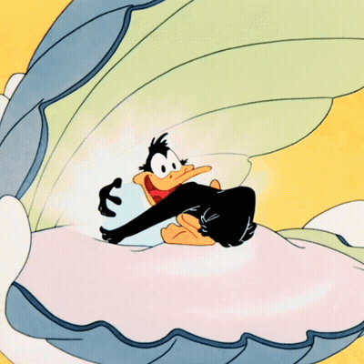 A Cartoon Duck Is Sitting In A Shell GIF