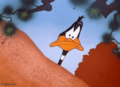 A Cartoon Duck Is Standing On Top Of A Hill Looking At The Camera . GIF
