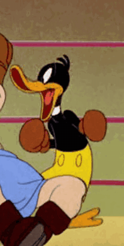 A Cartoon Duck Is Wearing Boxing Gloves And Kicking A Person . GIF