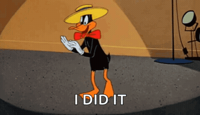 A Cartoon Duck Wearing A Hat And Bow Tie Is Standing On A Stage . GIF