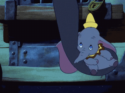 A Cartoon Elephant Hanging From A Trunk With A Yellow Hat On GIF